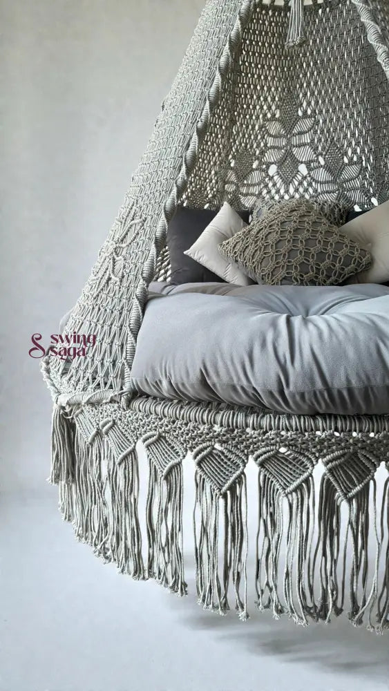 Macrame grey bed swing in simple background.