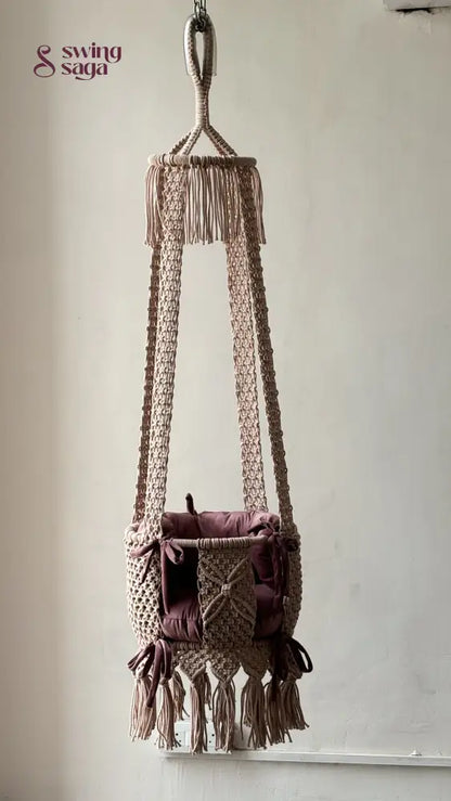 Full image of baby pink macrame handcrafted swing in a room setting. 