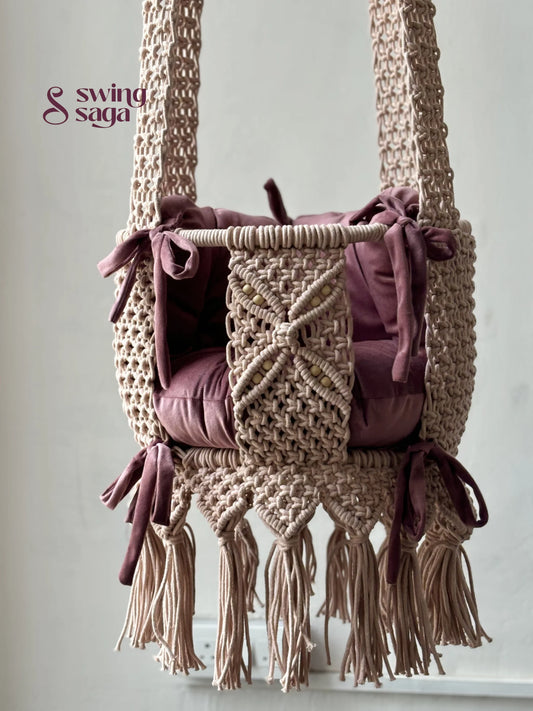 Macrame baby swing handcrafted in baby pink color with tassels on the bottom.