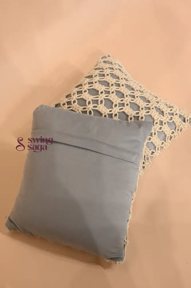 Gray pillow with lace trim on a beige background