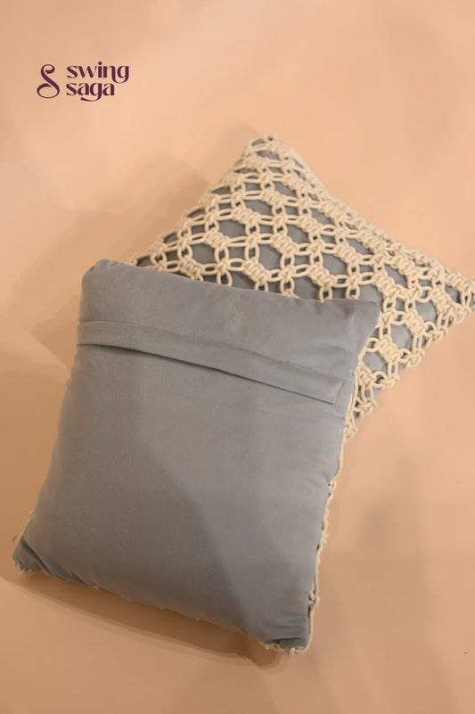 Gray pillow with lace trim on a beige background
