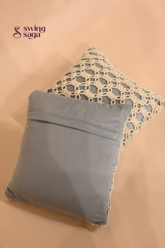Gray pillow with lace trim on a beige background