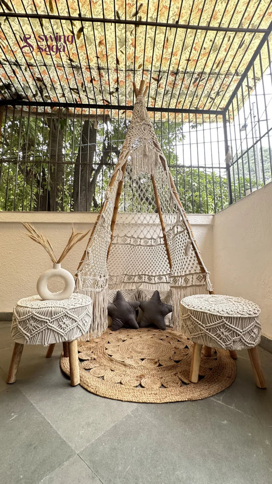 Small white macrame teepee with a pair of ottomans in white.
