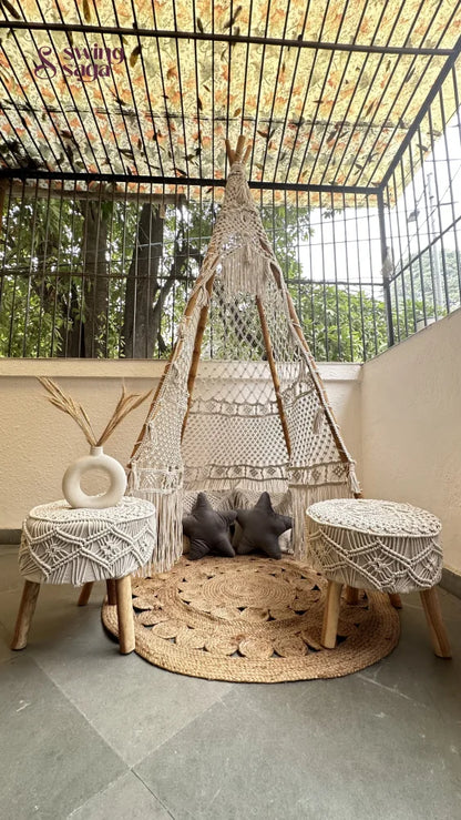 Small white macrame teepee with a pair of ottomans in white.