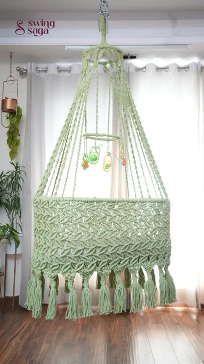 A lime green colored macrame baby cradle in a nursery room.
