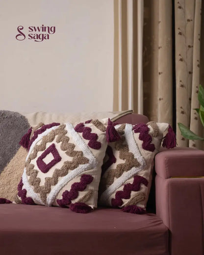 Decorative pillows with geometric patterns on a sofa against a neutral wall.