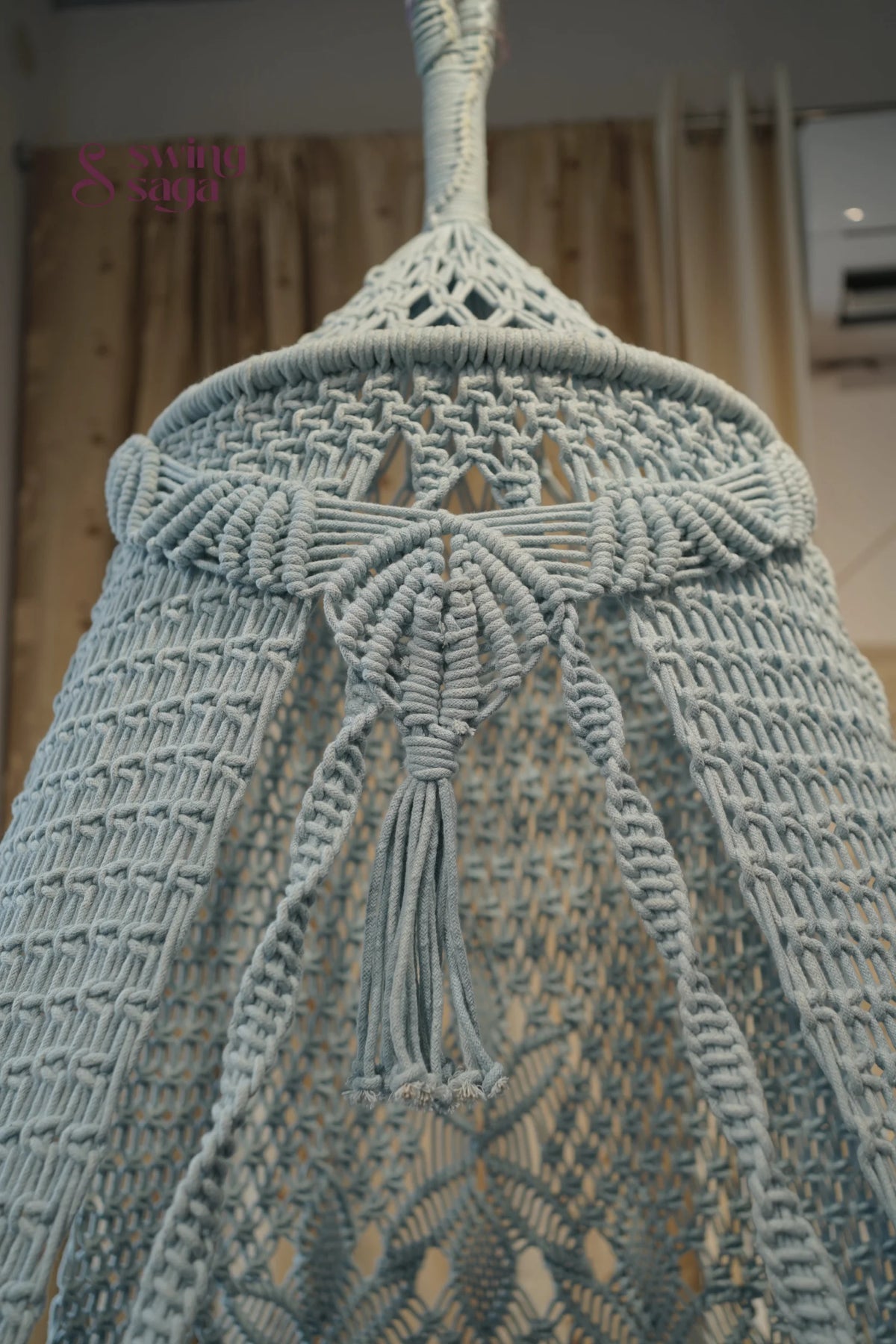 Close-up of a textured fabric with tassels on a blurred background