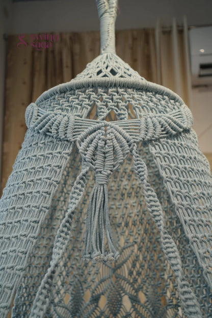 Close-up of a textured fabric with tassels on a blurred background