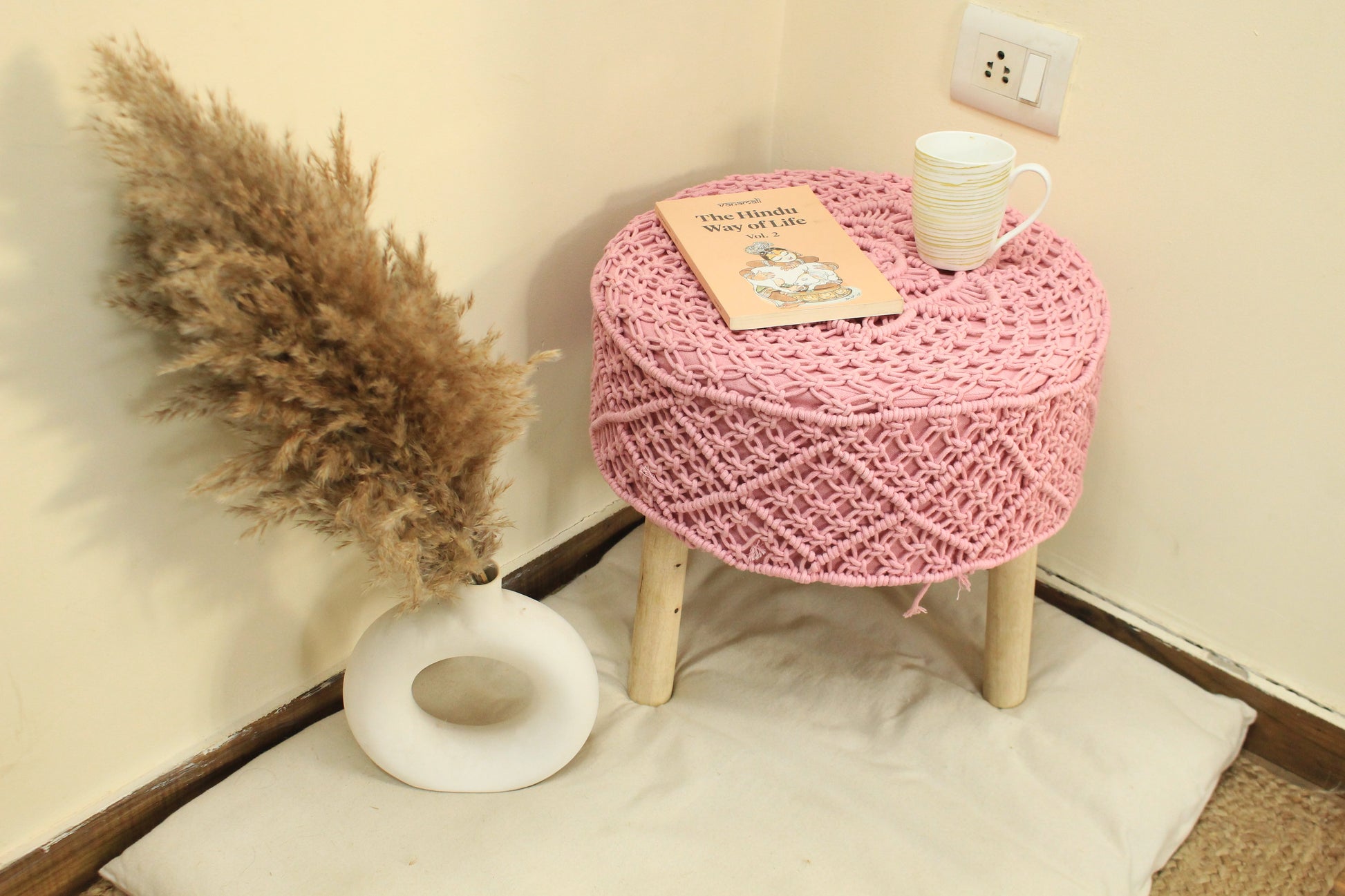 Handmade pink macrame ottoman with wooden legs
