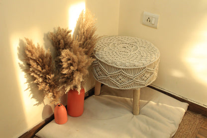 white macrame handcrafted ottoman with  terracotta vases