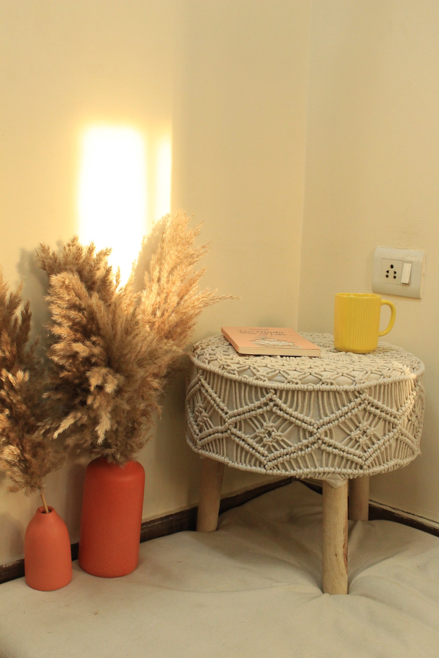 white macrame handcrafted ottoman with  terracotta vases