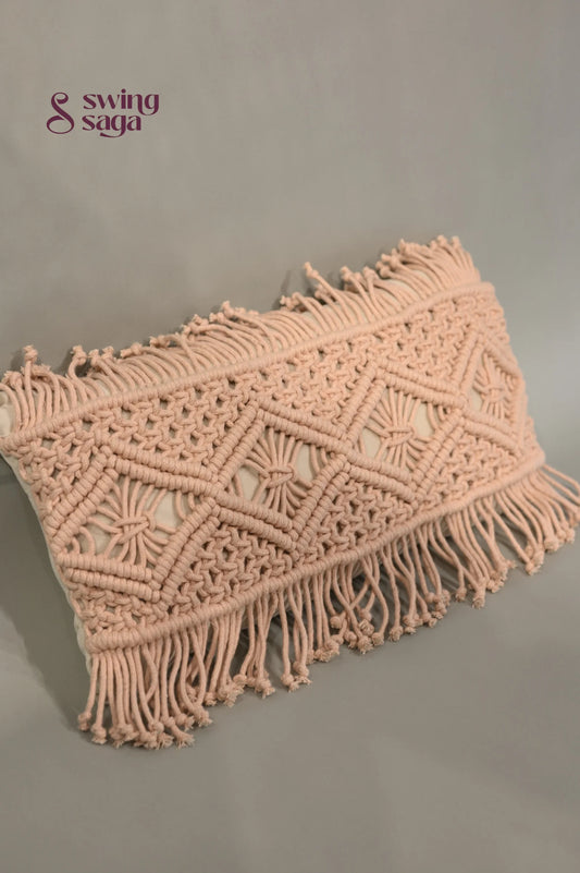 Pink macrame clutch bag with fringes on a gray background