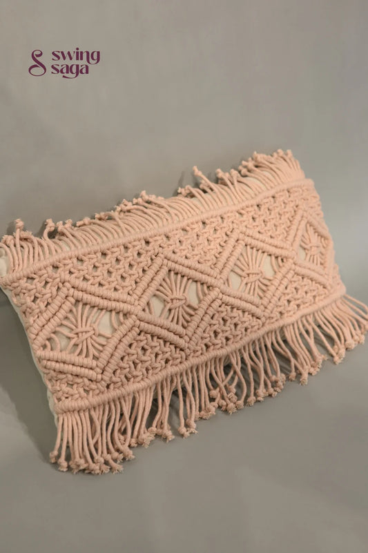 Pink macrame clutch bag with fringes on a gray background