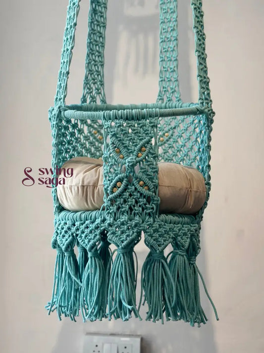Blue macrame handcrafted baby swing in a room setting