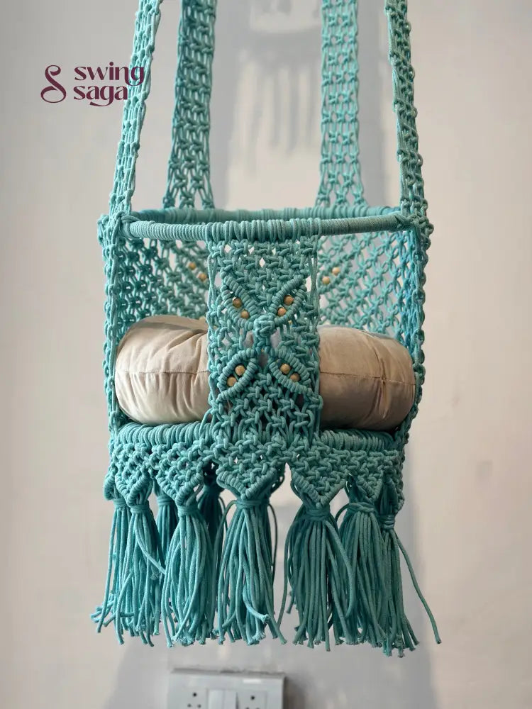 Blue macrame handcrafted baby swing in a room setting