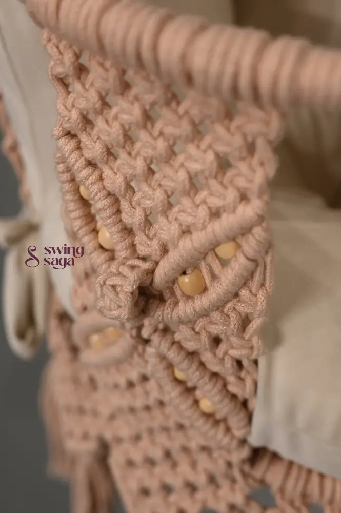 Close-up of a textured beige fabric of macrame baby swing