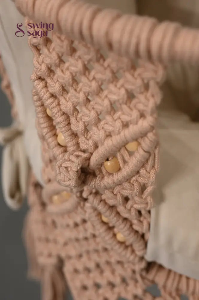 Close-up of a textured beige fabric of macrame baby swing