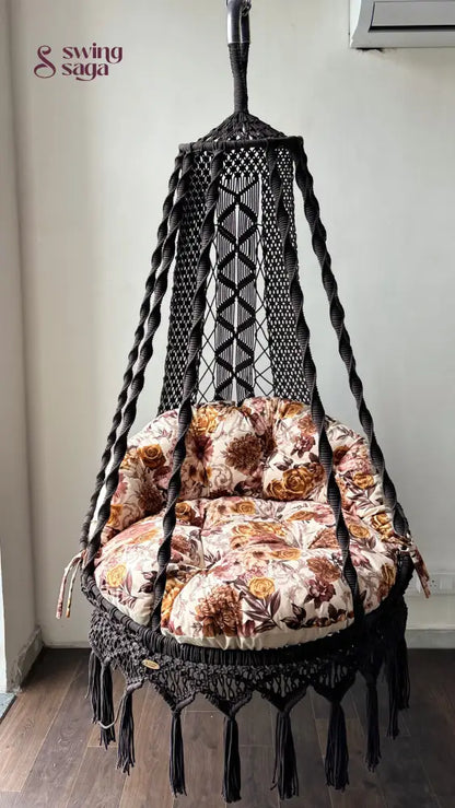 Hanging chair hammock swing with floral print mattress.