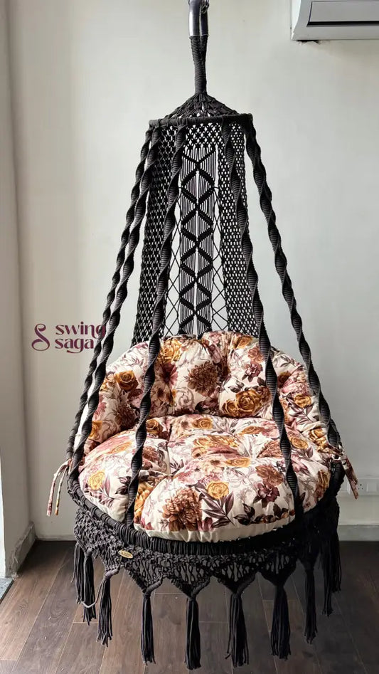 Hanging chair hammock swing with floral print mattress.