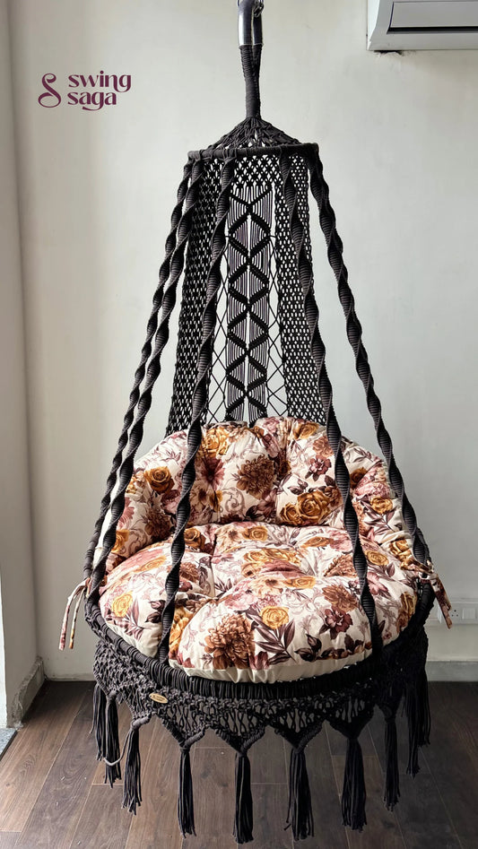 Hanging chair hammock swing with floral print mattress.