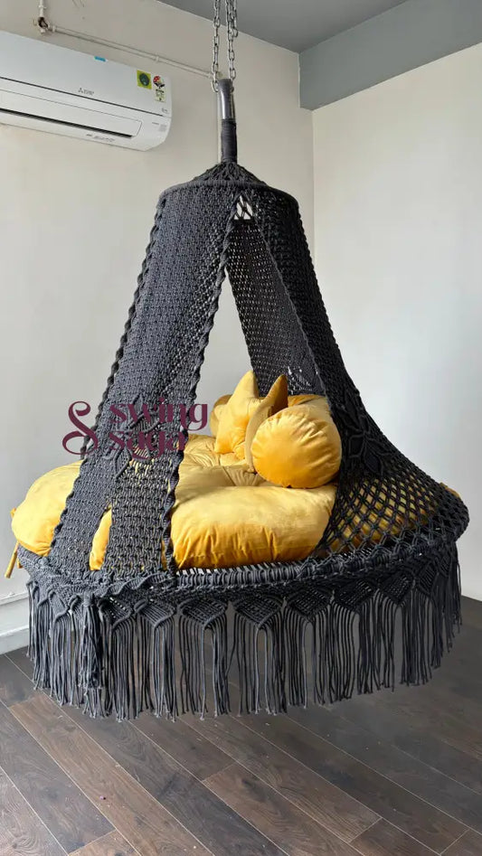 angled view of handmade grey hammock bed swing with yellow mattress for comfort and relaxation. 