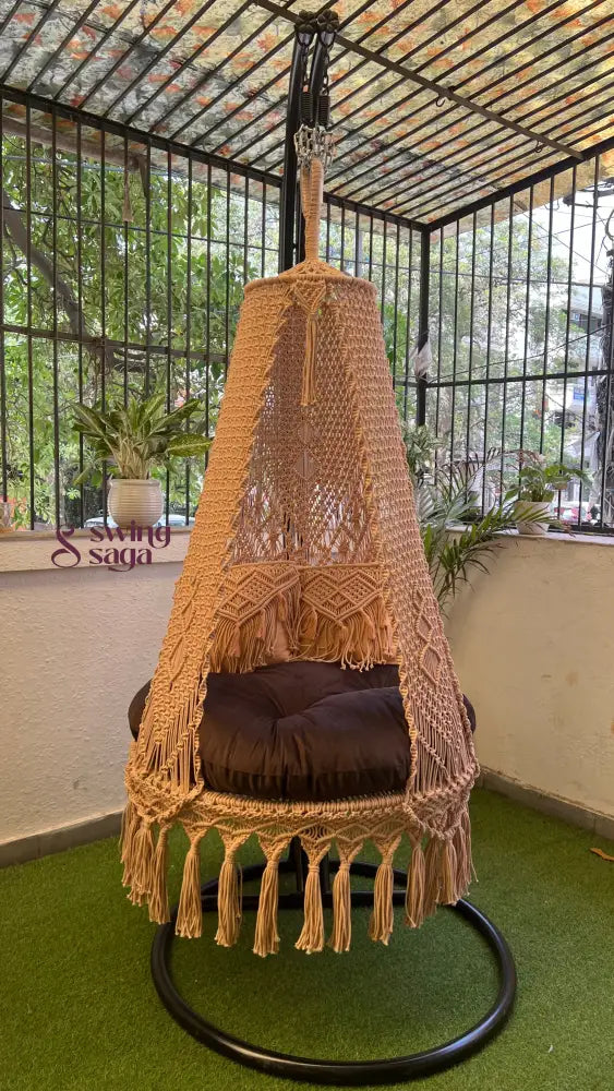 macrame swing in beige color with metal stand.