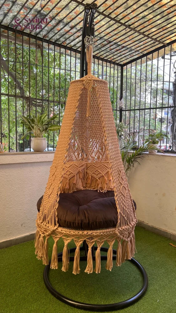 macrame swing in beige color with metal stand.