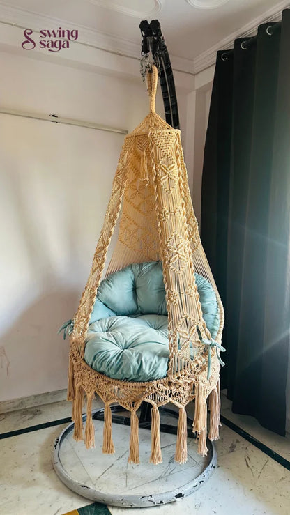 indoor chair swing with a black metal stand.