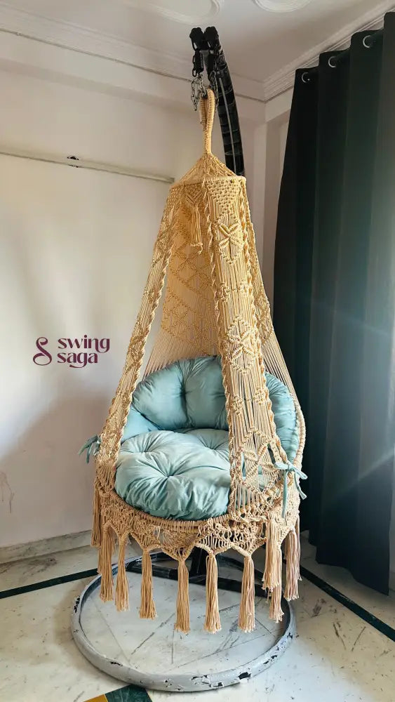 indoor chair swing with a black metal stand.