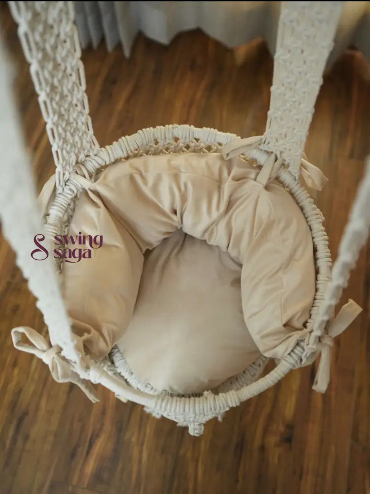 Inside image of mattress in white colored of a macrame baby swing.