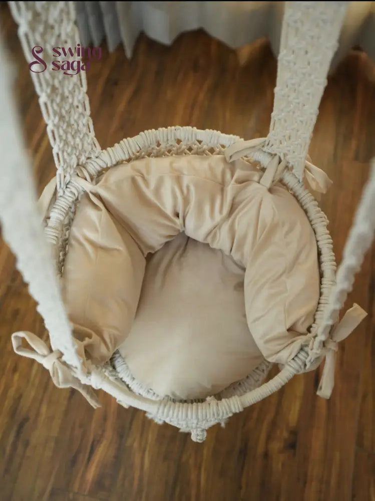Inside image of mattress in white colored of a macrame baby swing.