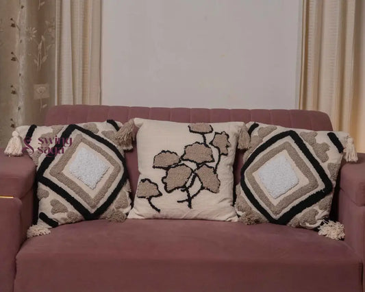 Cream and black patterned cushion with decorative fabric design.