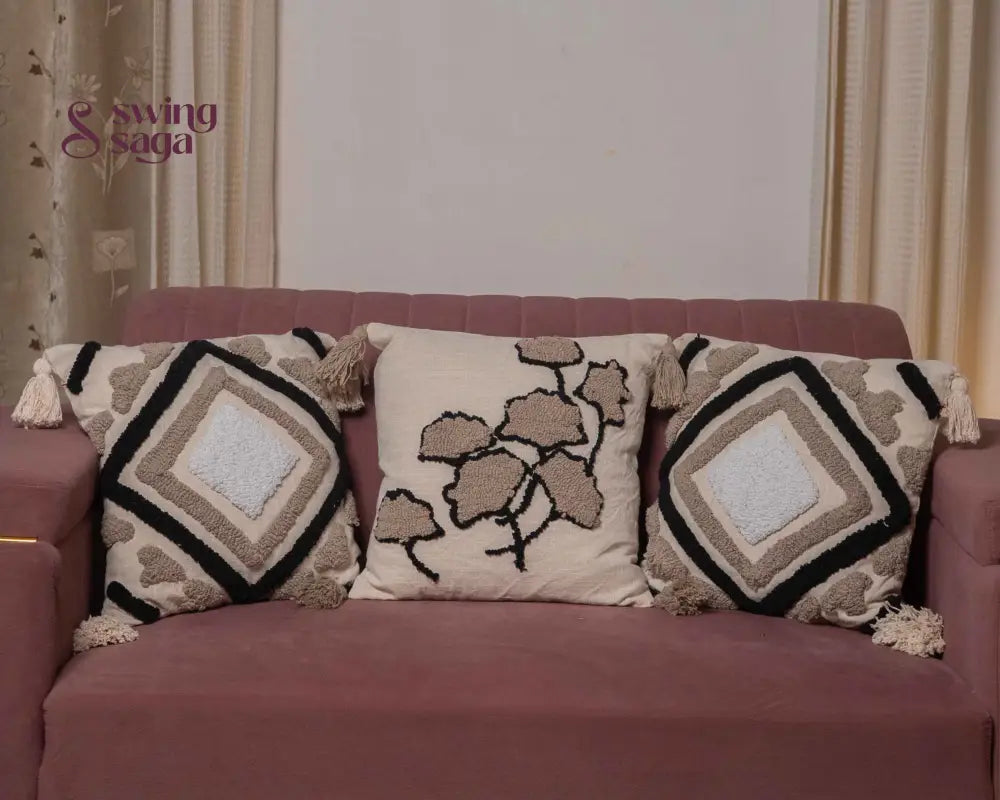 Cream and black patterned cushion with decorative fabric design.