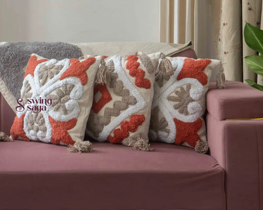 3 pair of cushions on a sofa agiant a neutral wall.