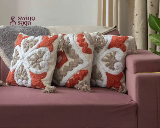 3 pair of cushions on a sofa agiant a neutral wall.