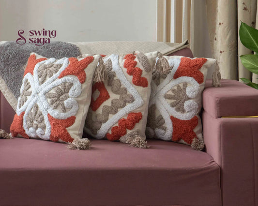 3 pair of cushions on a sofa agiant a neutral wall.