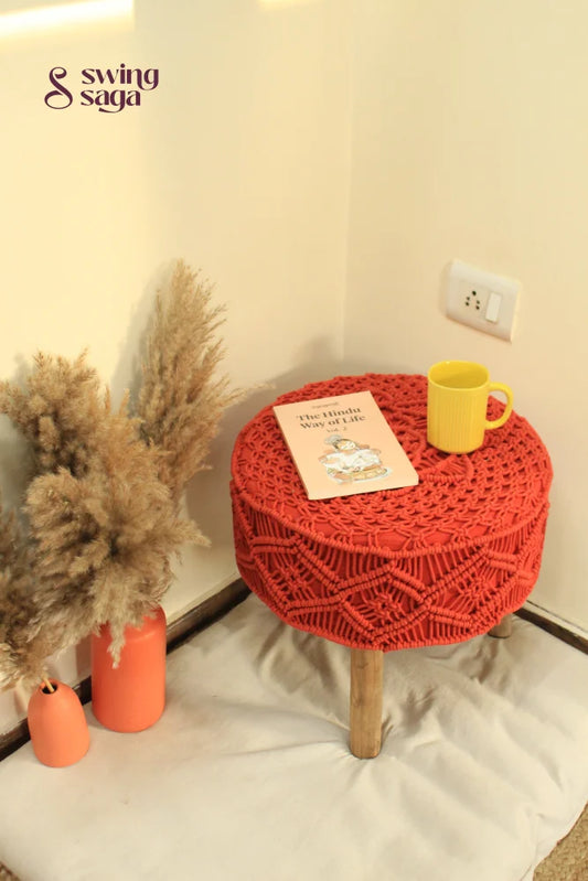 Orange Macrame Ottoman with yellow coffee mug and terracotta vase.