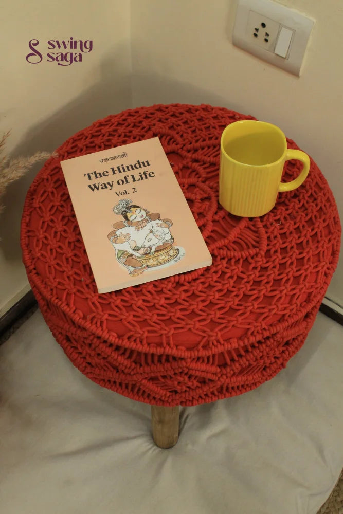 Orange Macrame Ottoman with yellow coffee mug and terracotta vase.