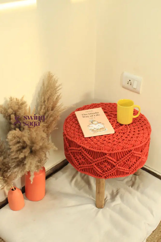 Orange Macrame Ottoman with yellow coffee mug and terracotta vase.