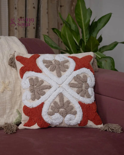 Square shaped cushion in orange and white color.