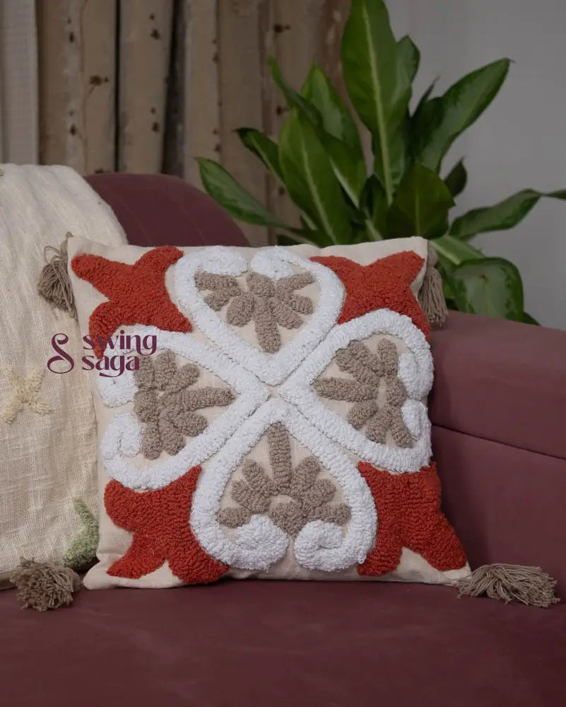 Square shaped cushion in orange and white color.