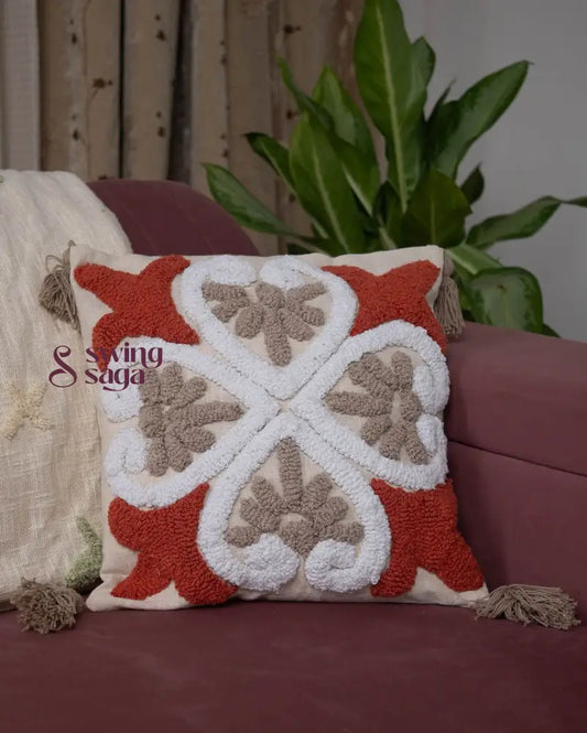 Square shaped cushion in orange and white color.