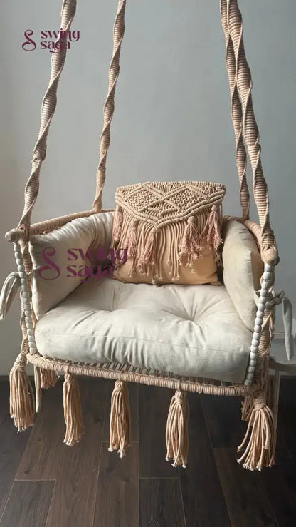 hanging macrame swing in peach color.