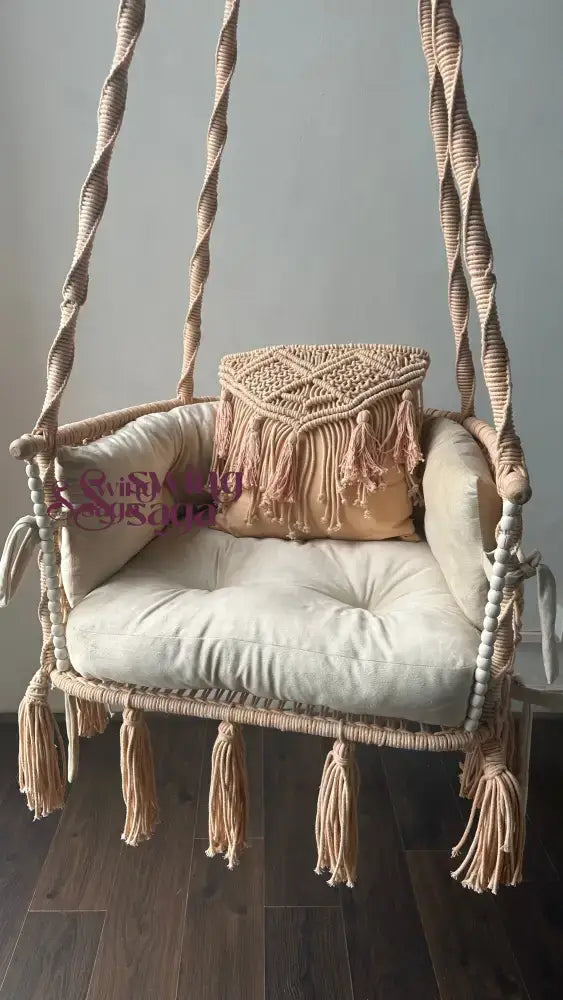 hanging macrame swing in peach color.