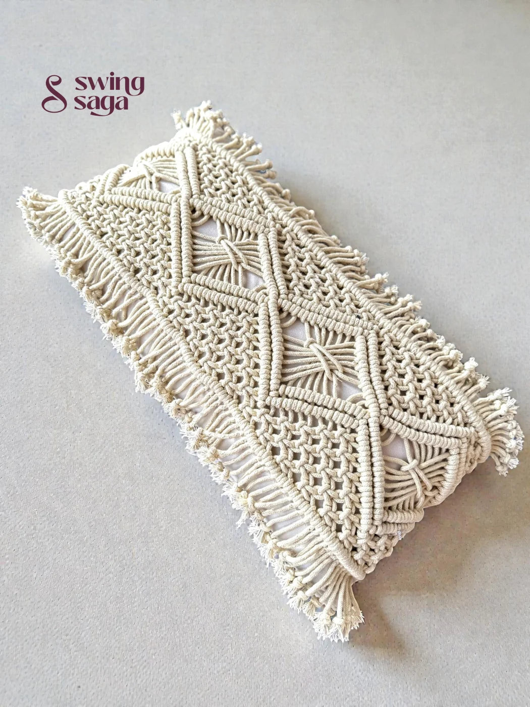 Macrame phone case with geometric pattern on a light gray background